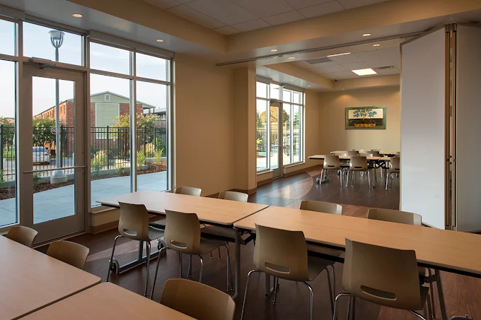 Dining room with tables, chairs, and large windows