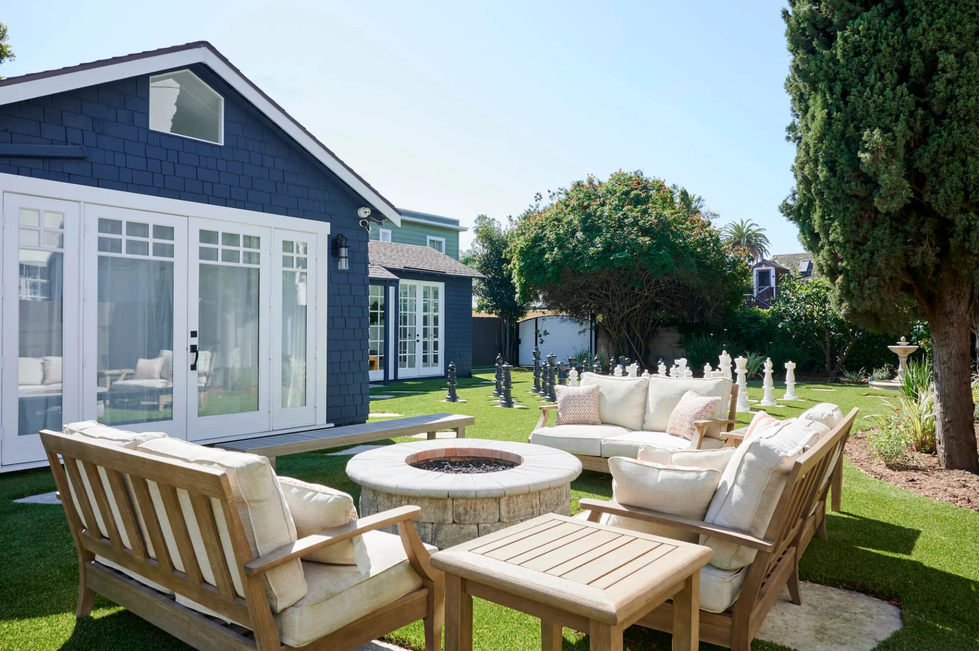 Outdoor seating area with firepit and garden lawn