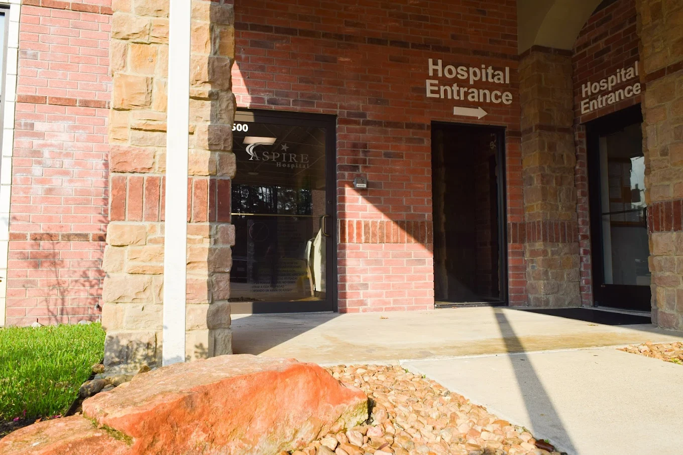 Glass door under covered brick hospital entryway