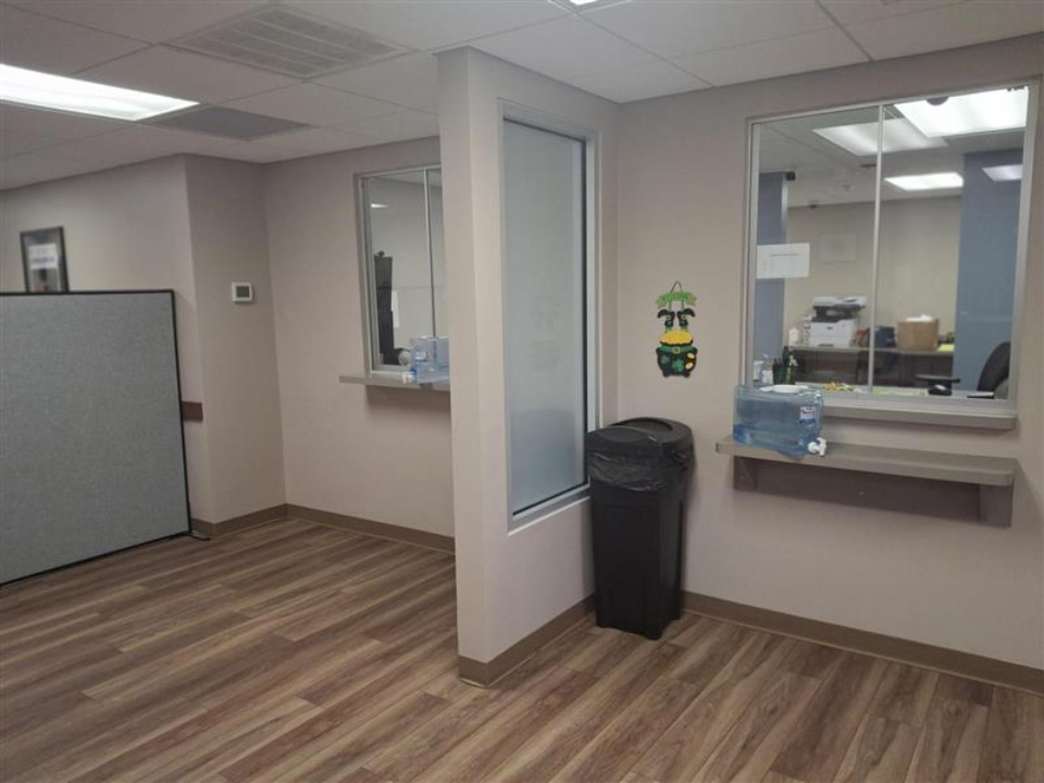 BrightView Health Batavia dispensing area with service windows, counters, water dispenser, and wood-look flooring