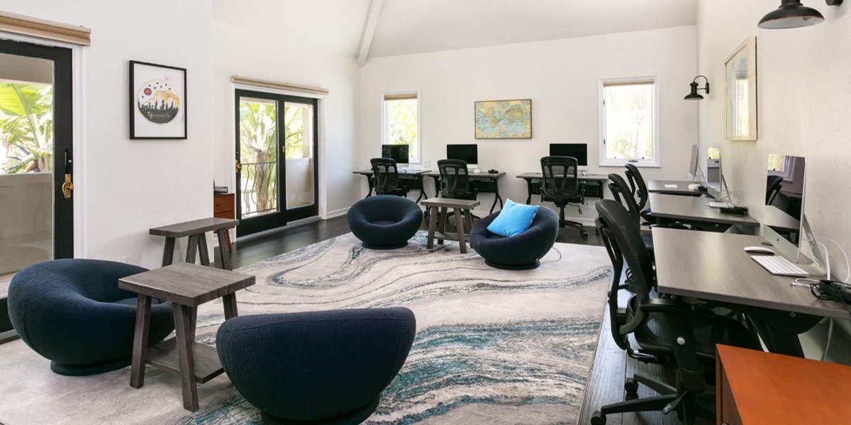 Shared study room with computers, seating, and natural light