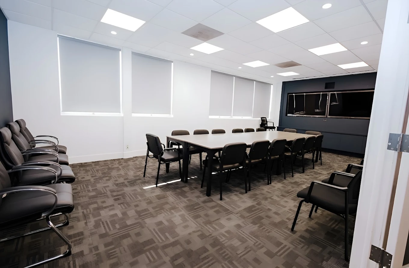 Meeting room with large table and chairs arranged around it