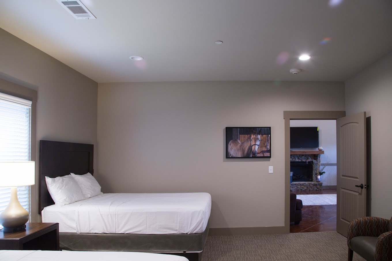Double-bed rehab room with horse artwork on the wall