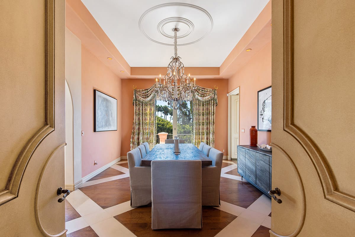 Formal dining room with chandelier and large windows