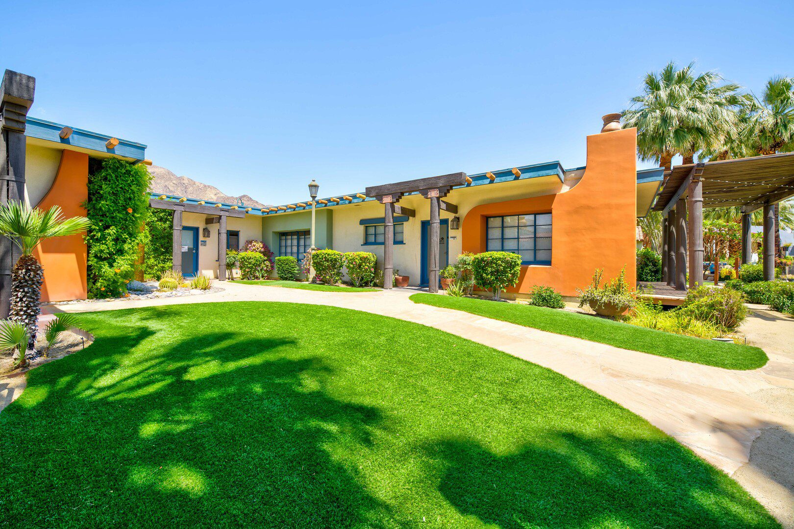 Landscaped courtyard with lawn and desert-style buildings