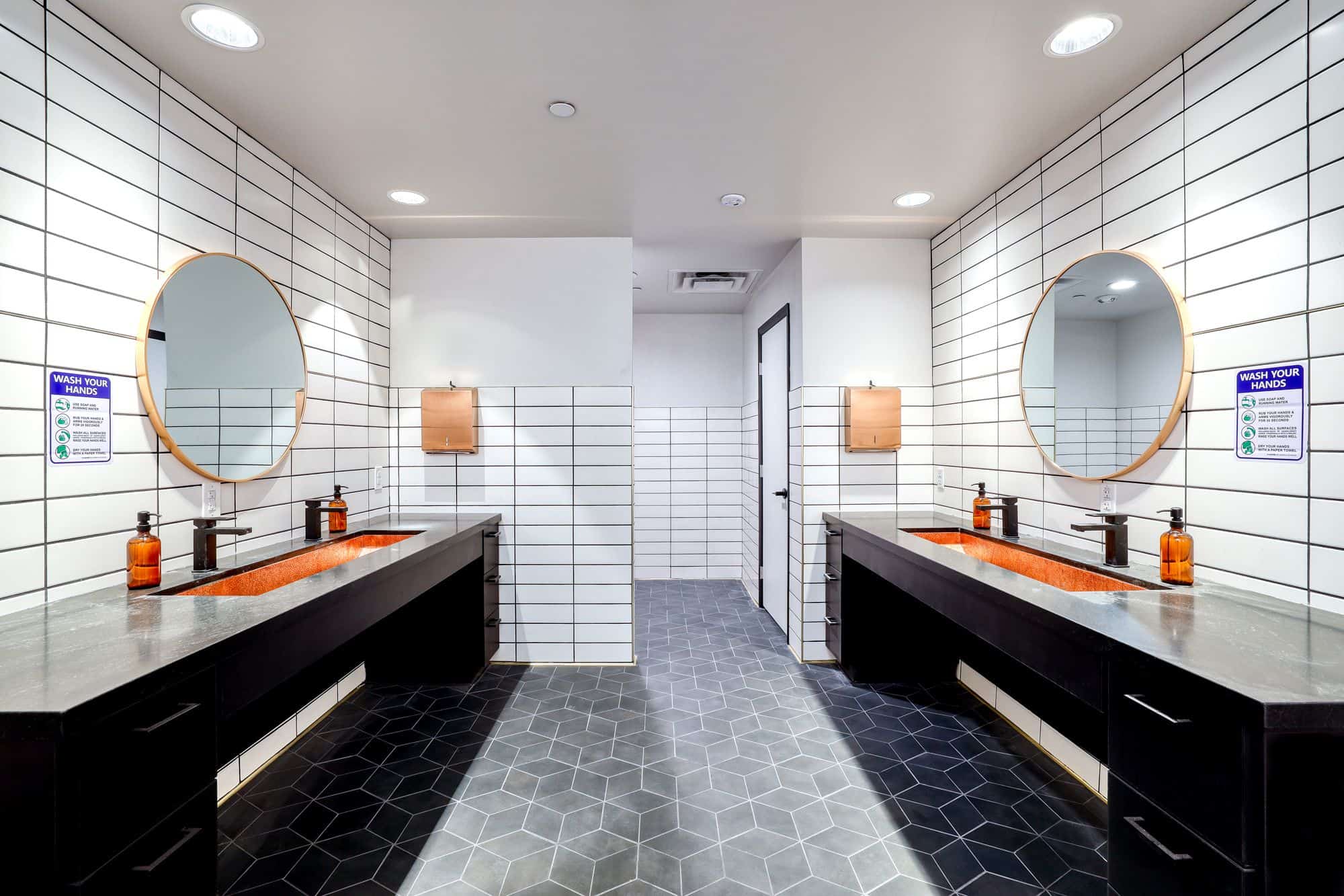 Modern shared bathroom with double vanities and mirrors