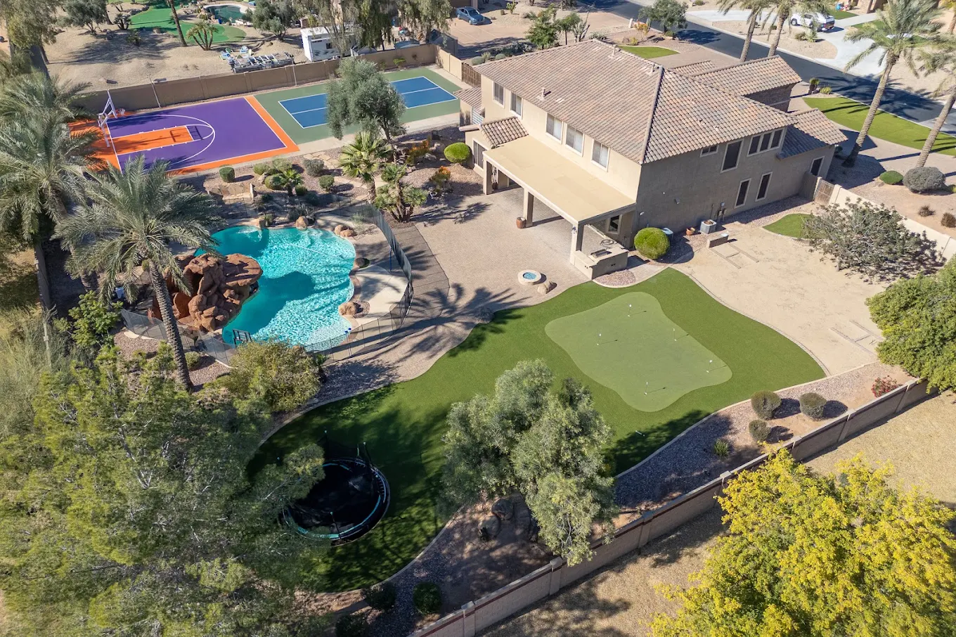 Aerial view of residential treatment grounds with pool, putting green, and sports courts