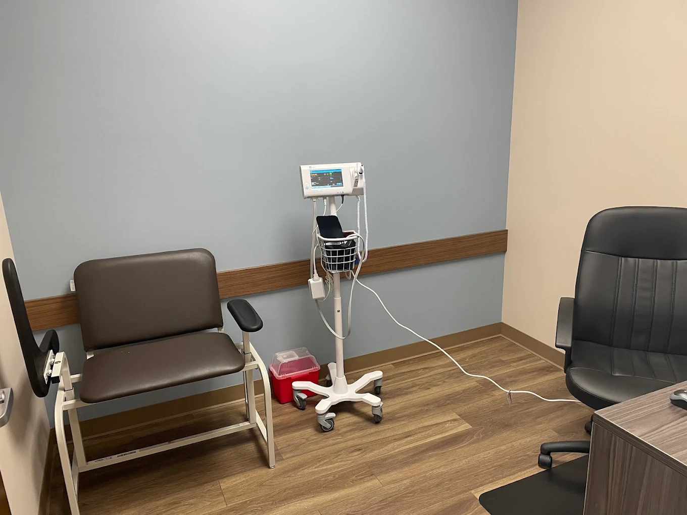 Exam room with patient chair and medical equipment