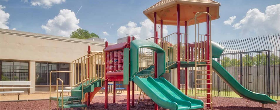 Secure outdoor playground with slides and climbing equipment