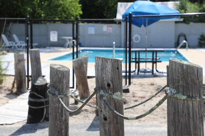 Outdoor swimming pool with lounge chairs and umbrella seating