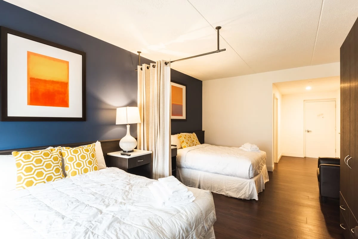 Room with two beds and privacy curtain