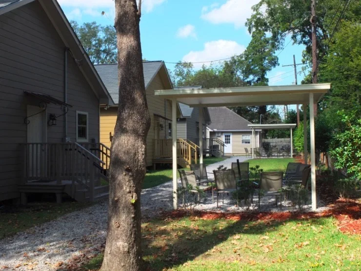 Covered patio area with chairs between cottages
