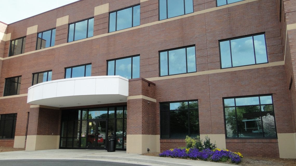 Exterior of brick outpatient center with windows and entry awning