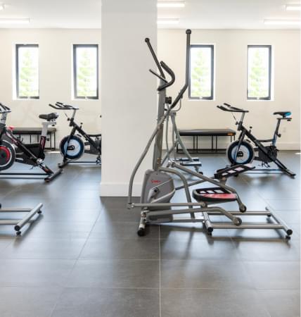 Stationary bikes and elliptical machines in a gym room