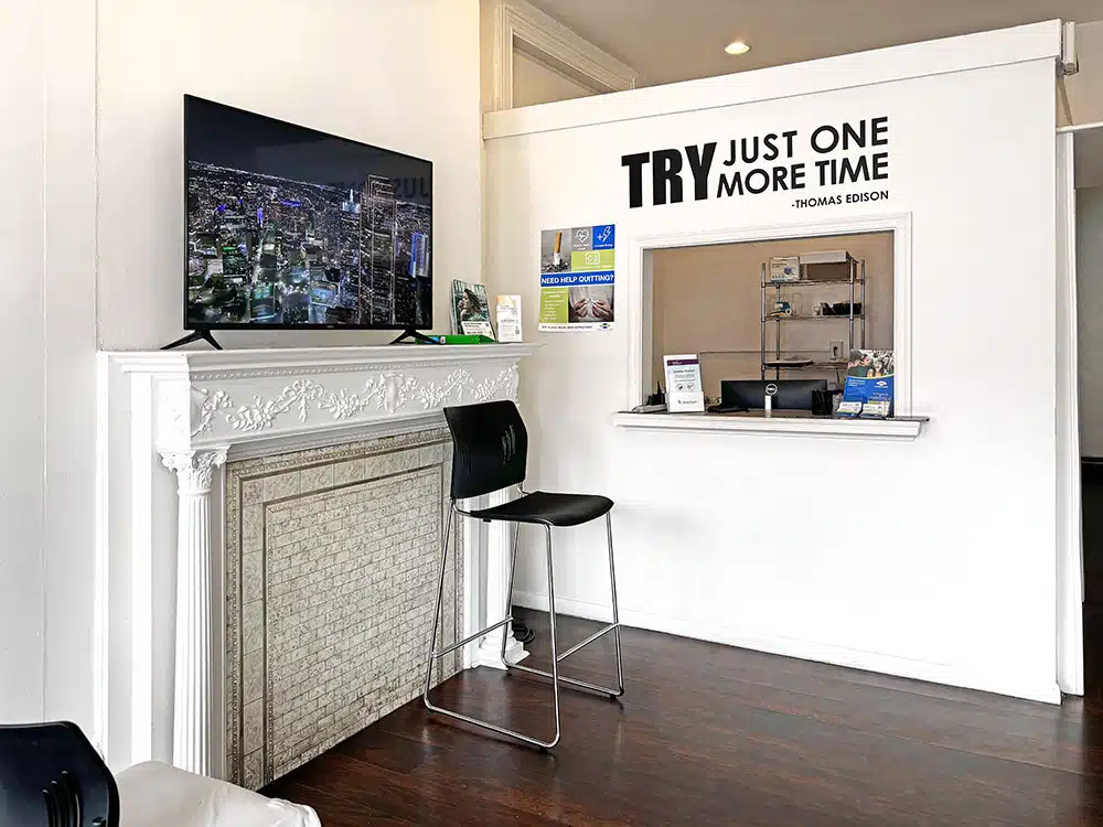 Reception window with motivational quote and TV nearby