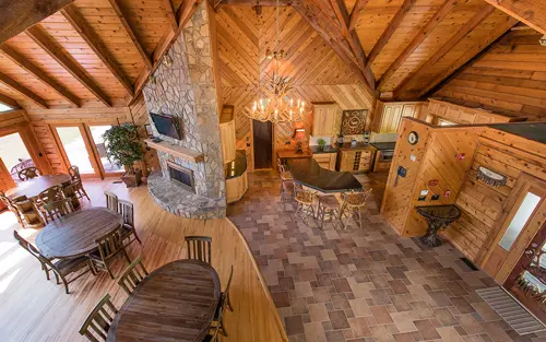 Rustic great room with fireplace and dining area
