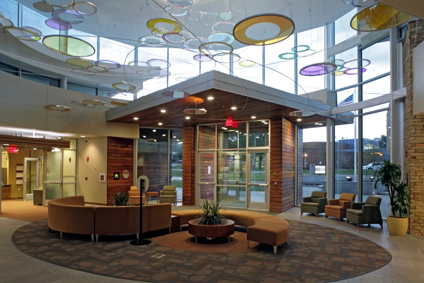 Spacious lobby with curved seating and colorful ceiling art