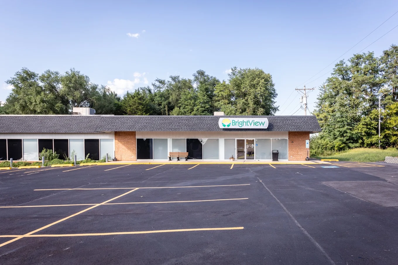 Front view of BrightView Harrisonburg treatment center with parking area and entrance