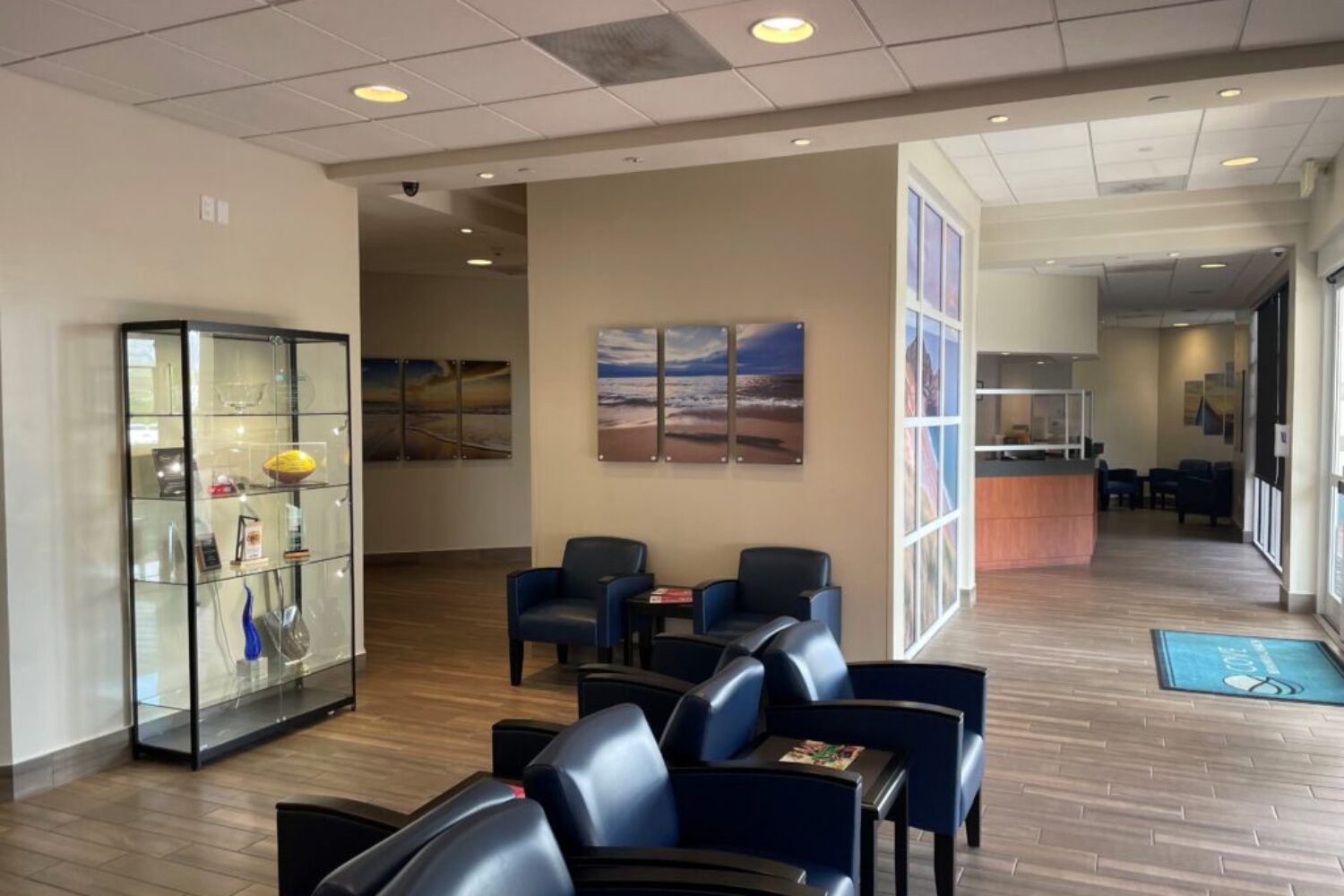 Modern facility lobby with seating and glass display cabinet