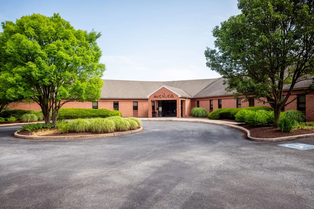Exterior view with circular driveway and trees