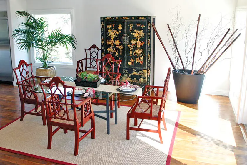 Glass table with red chairs in bright dining area