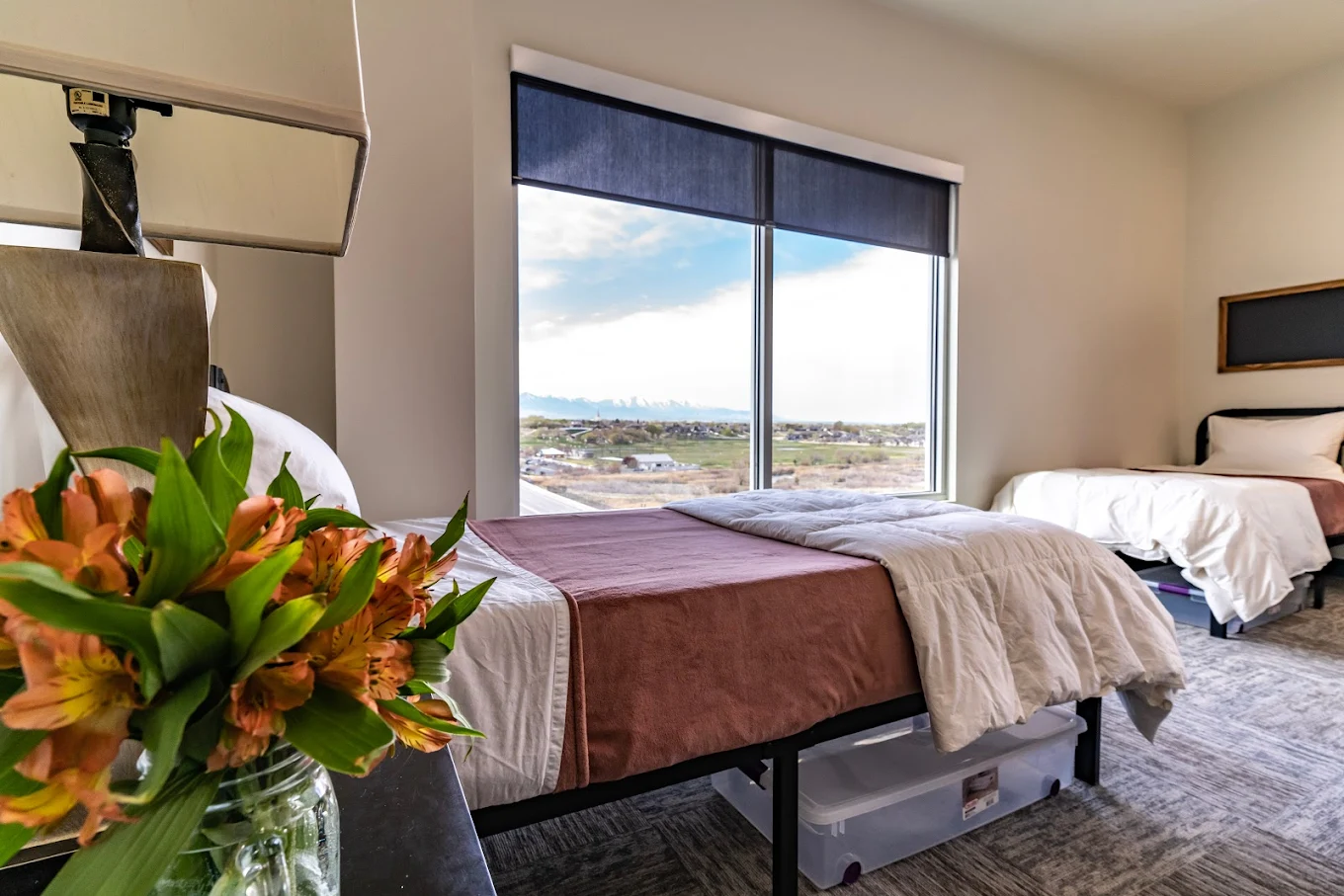 Shared bedroom with twin beds and mountain view