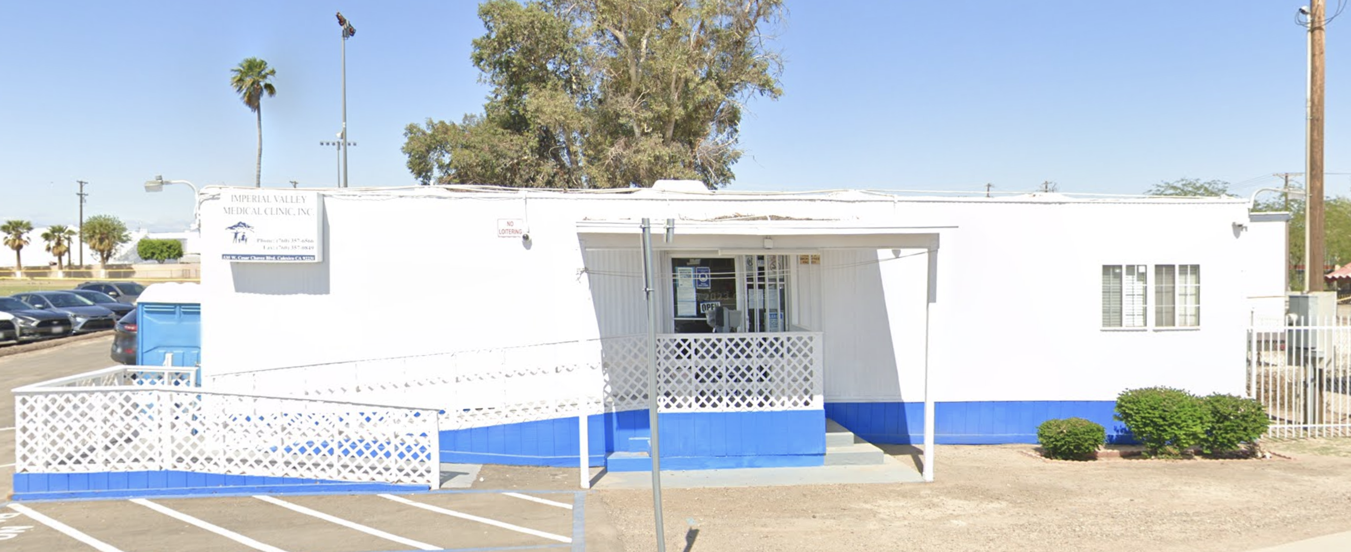 A bright and clean medical clinic with blue accents, featuring accessible parking and a welcoming entrance for visitors.