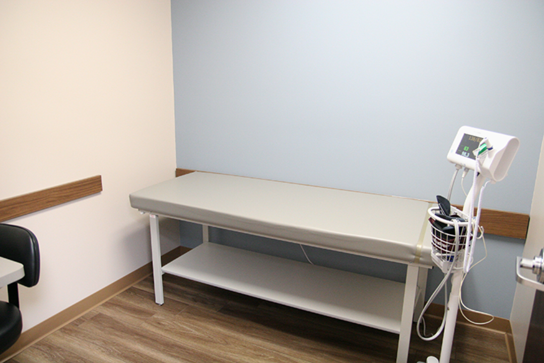 Exam room with medical table and monitoring equipment