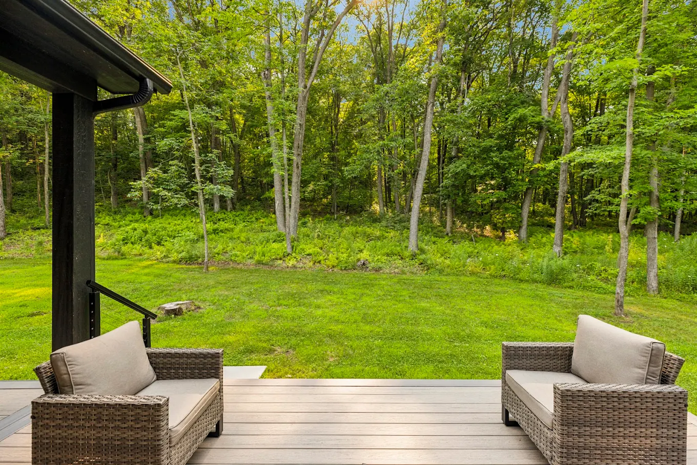 Patio seating with chairs facing the forest