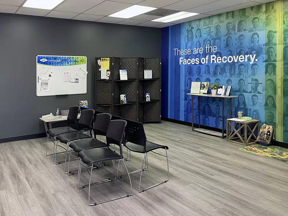 Waiting area with chairs and Faces of Recovery wall mural