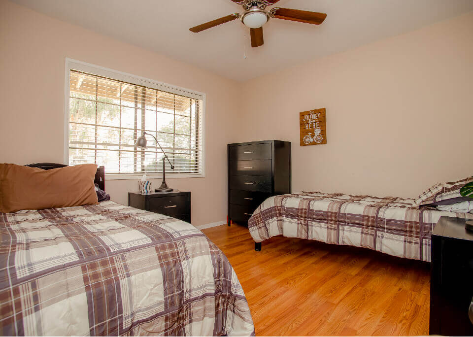 Bedroom with two twin beds and plaid bedding