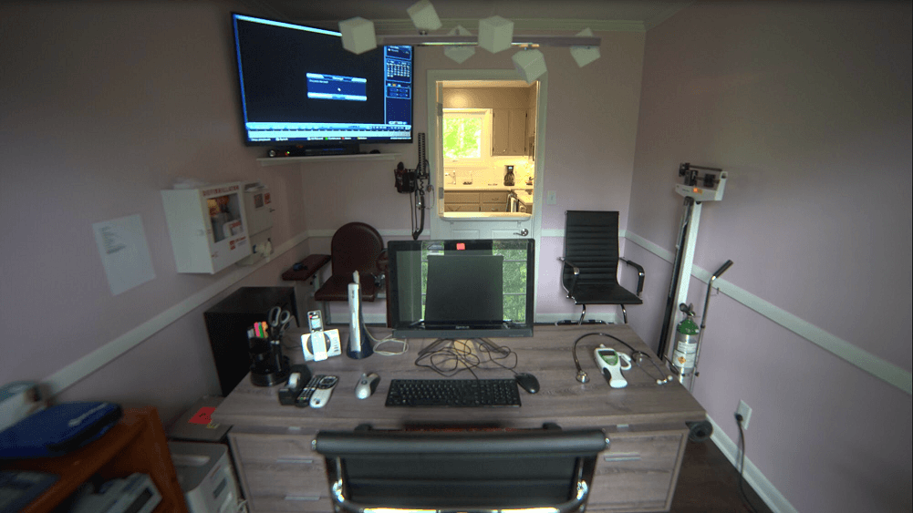 Counseling office with desk, computer, and medical equipment