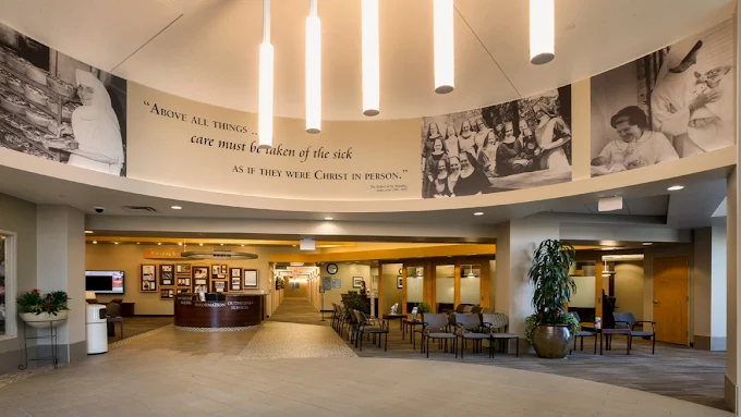 Curved lobby with chairs and wall art