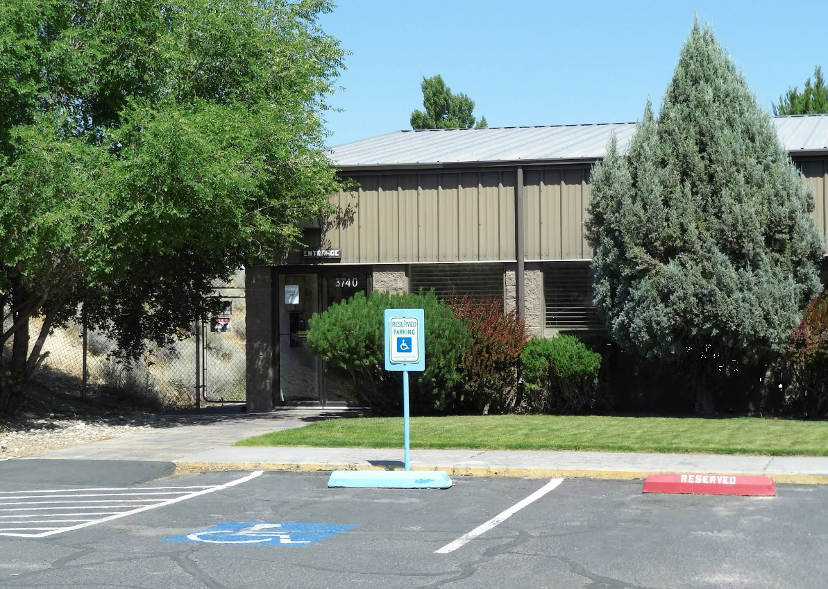 Facility entrance with reserved accessible parking space
