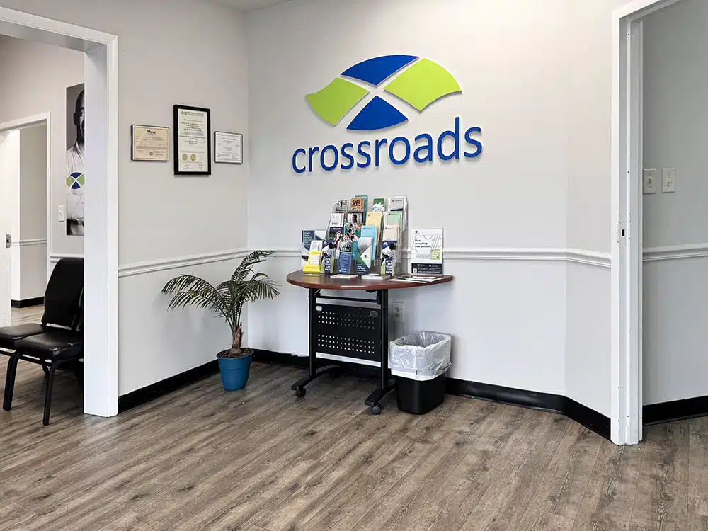 Lobby with Crossroads logo, brochures, and small table