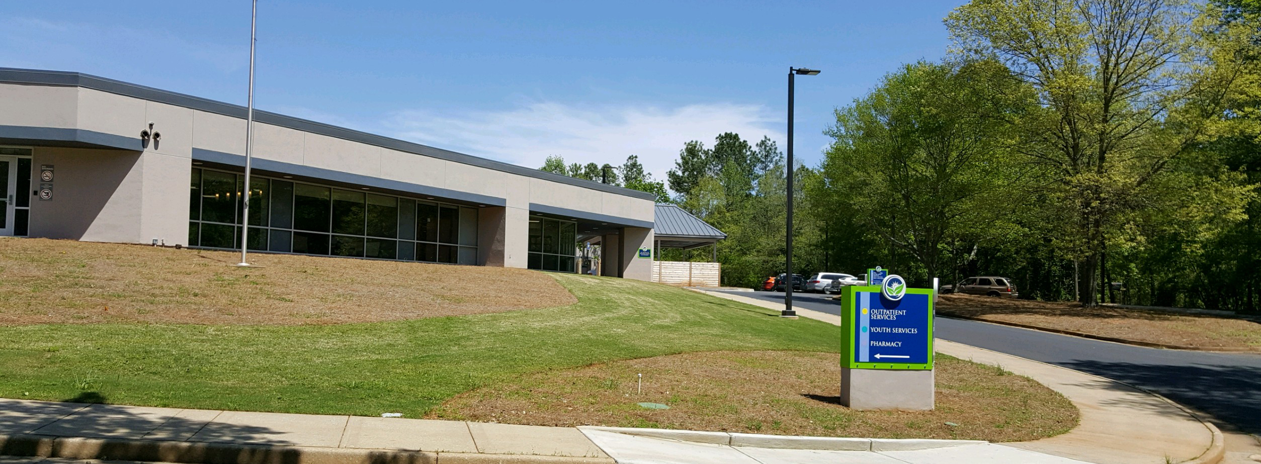 Behavioral health facility with sign and parking lot view