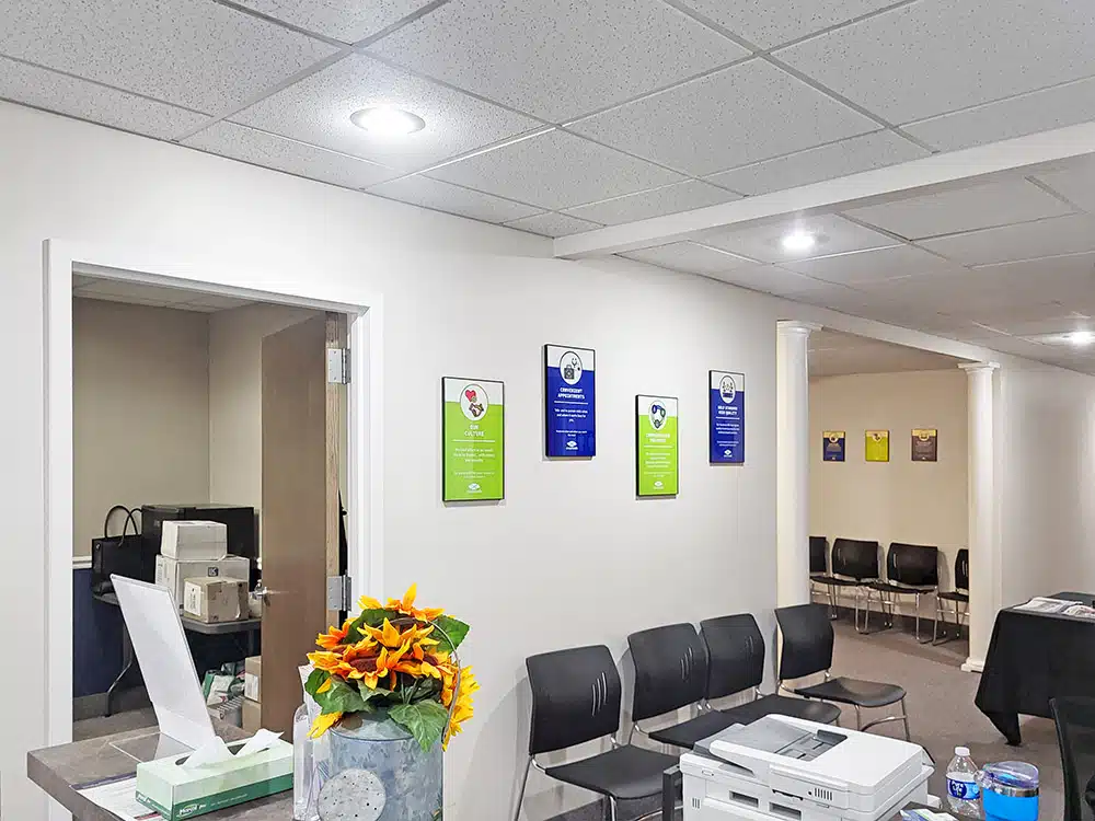 Waiting area with chairs, posters, and front desk