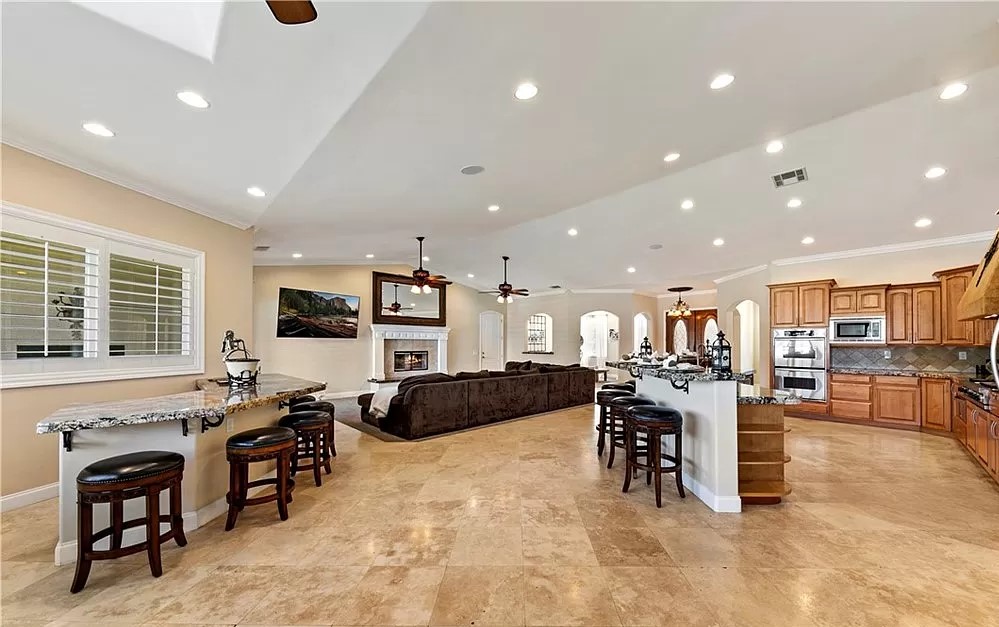 Living area with a fireplace and breakfast bar.