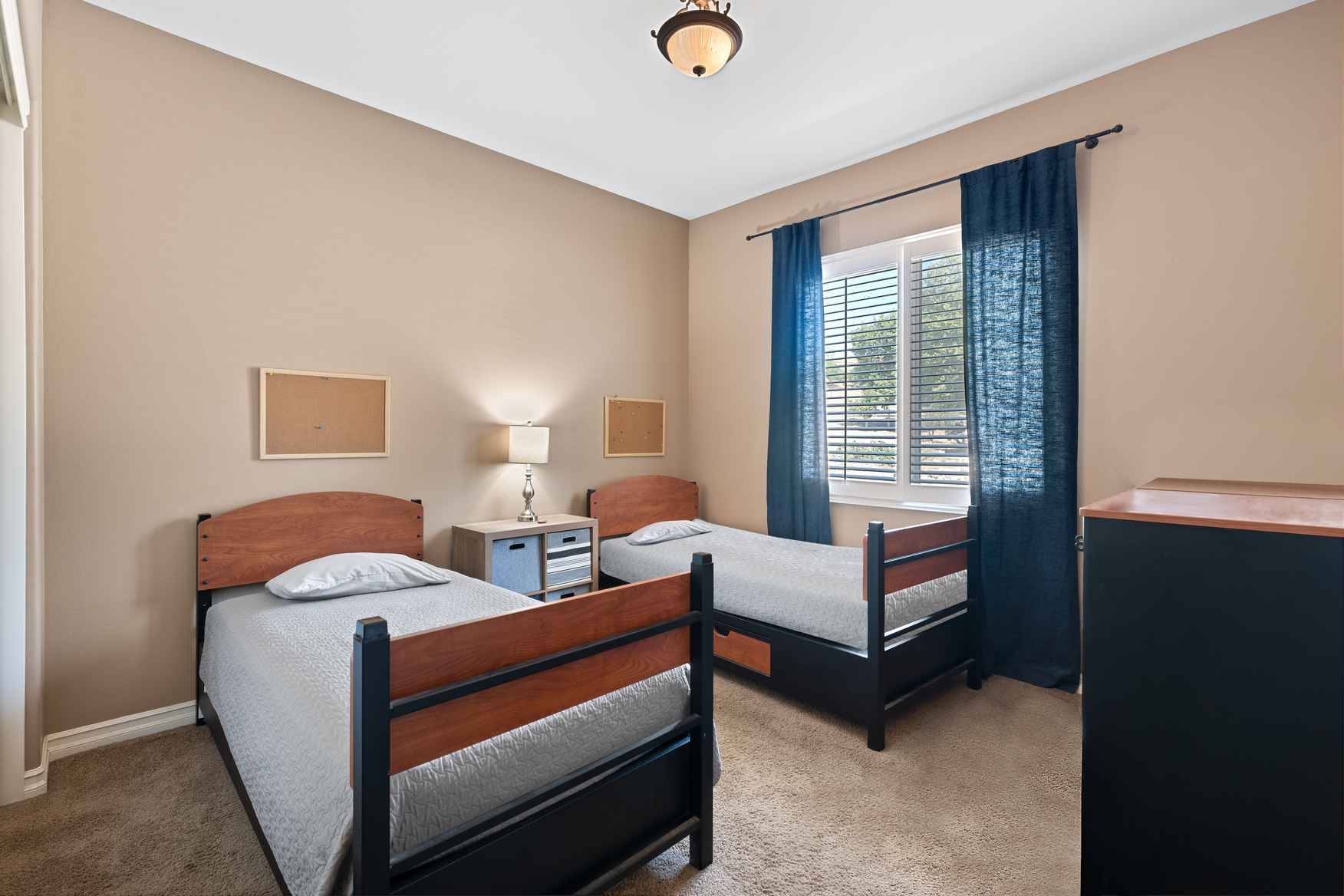 Twin beds in a simple, bright shared bedroom.