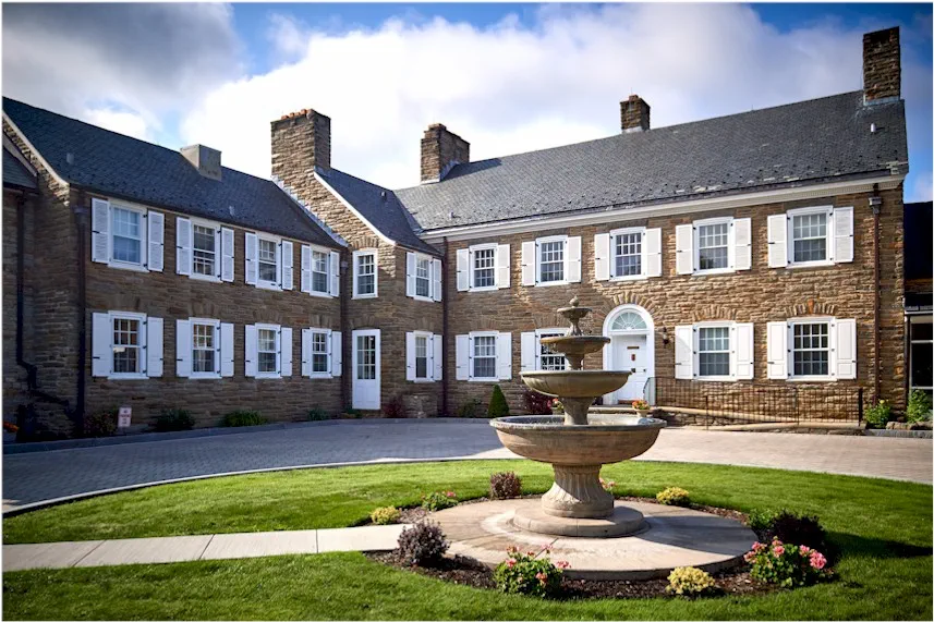 Landscaped courtyard with fountain outside treatment center.