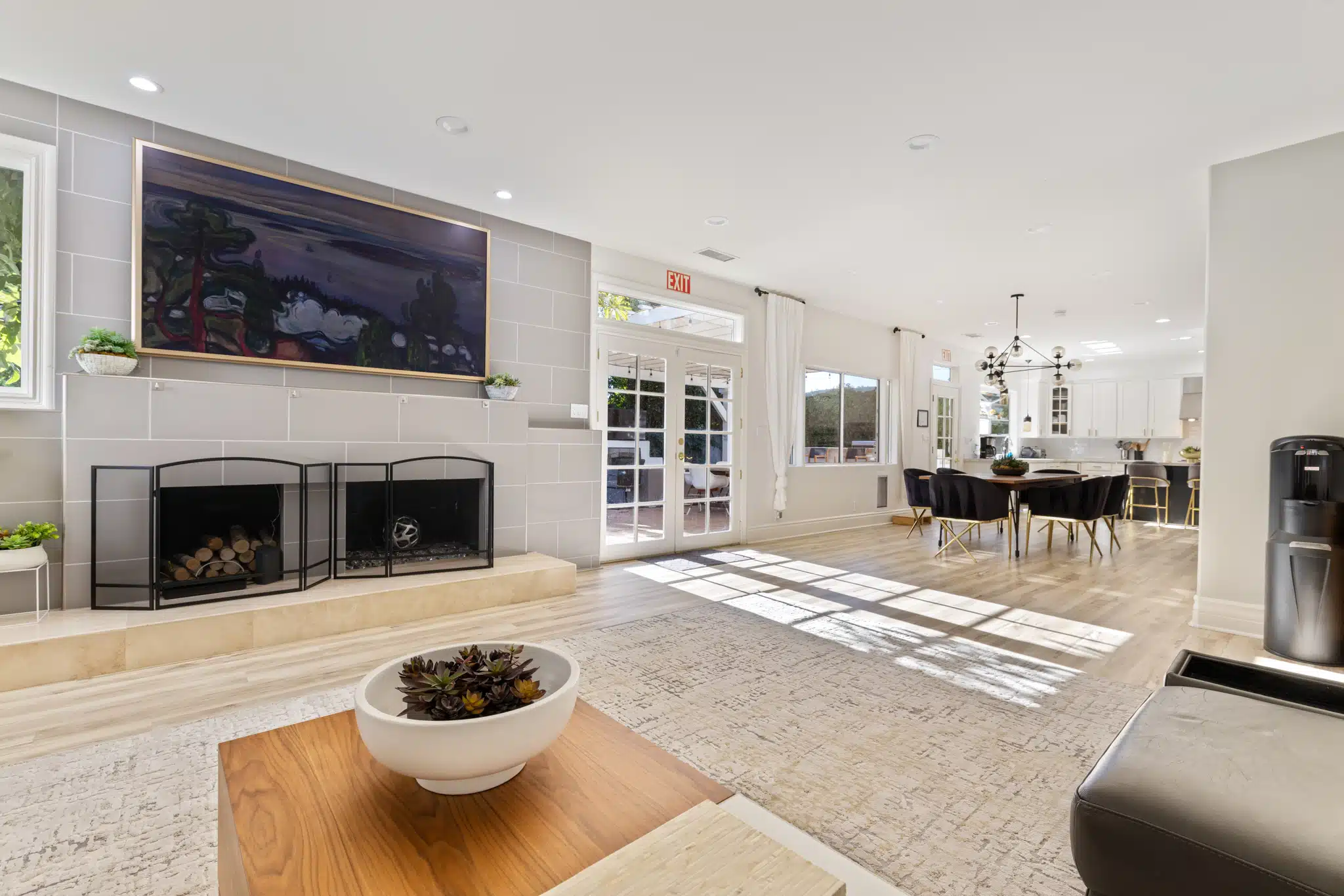 Open living and dining room with fireplace and modern decor.
