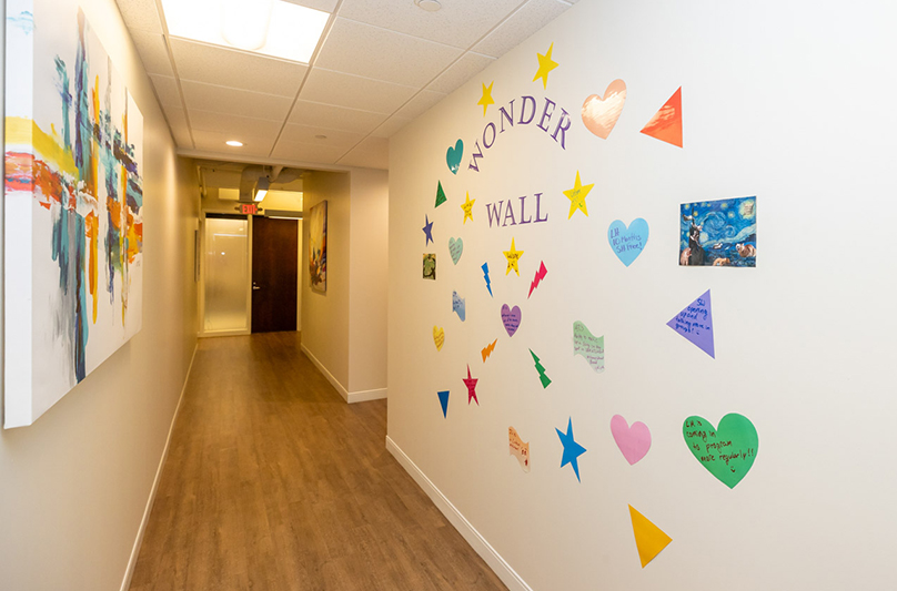 Bright hallway with colorful Wonder Wall artwork