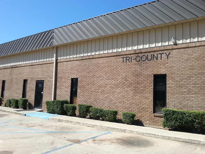 Brick building with "Tri County" signage and accessible parking.