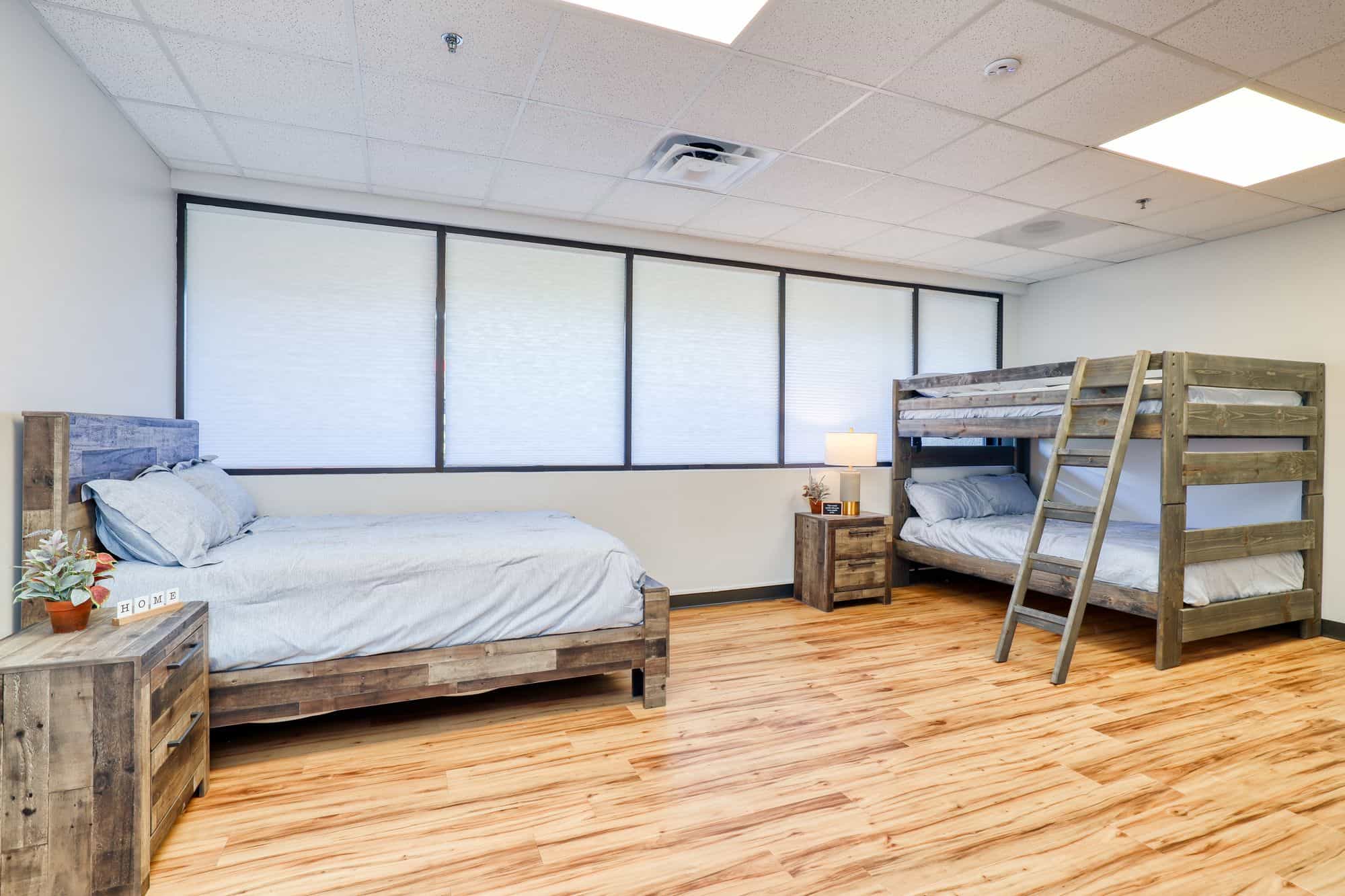 Shared bedroom with queen bed and bunk beds