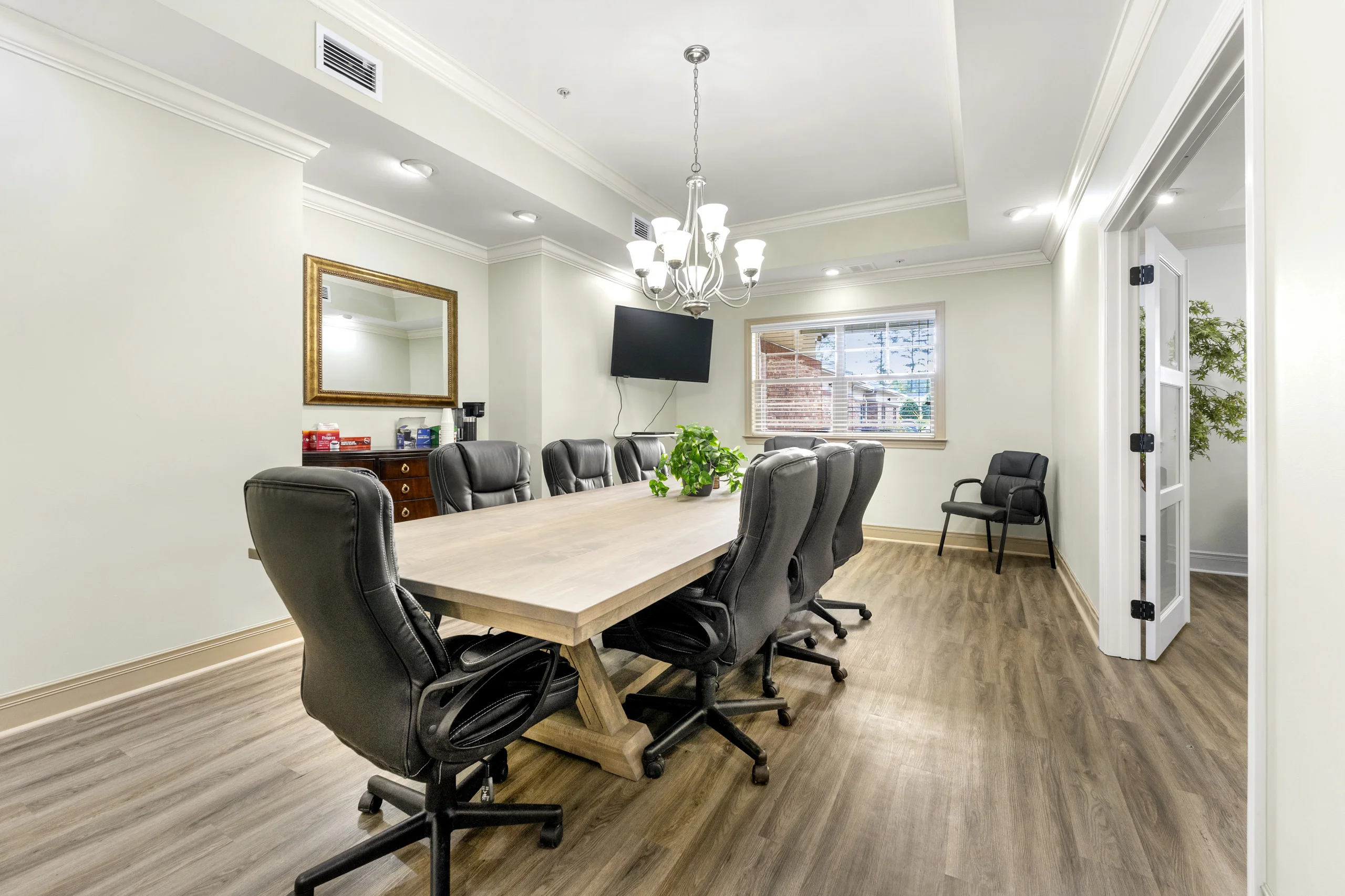 Lounge area with comfortable seating and fireplace located outside the family meeting room