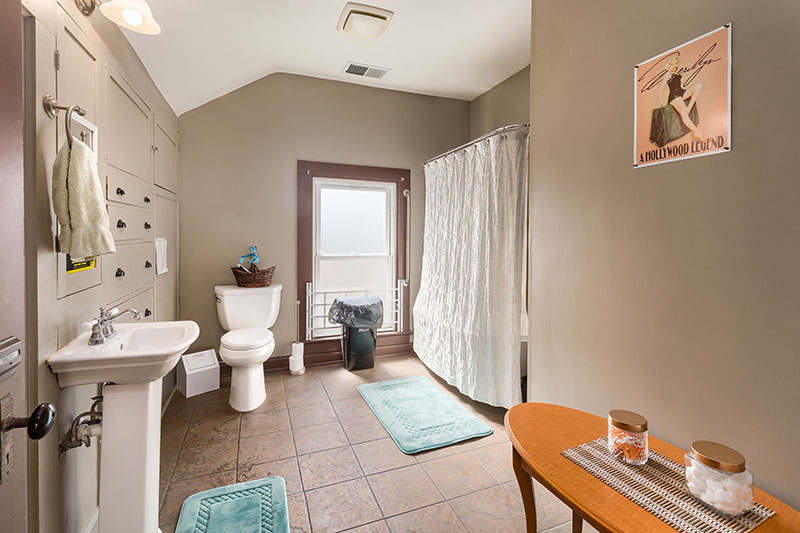 Residential bathroom with shower, sink, and toilet