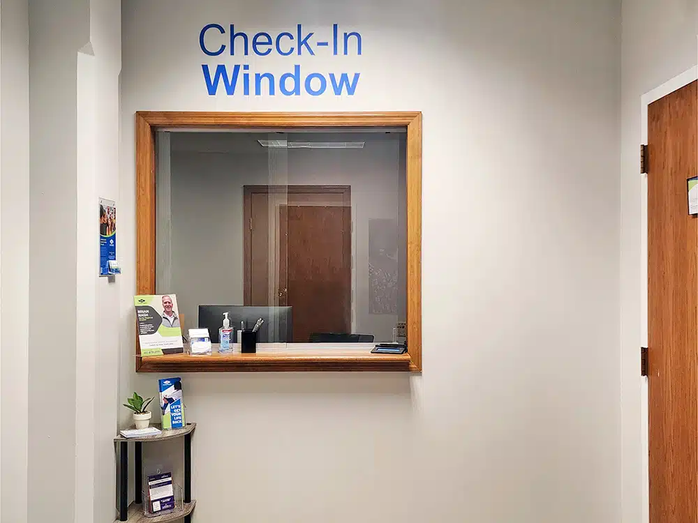 Check-in window with counter and small shelf display