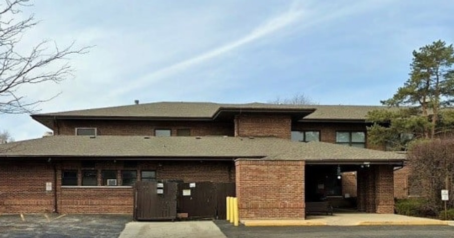 Front view of SHARE building with covered drop-off area and parking.