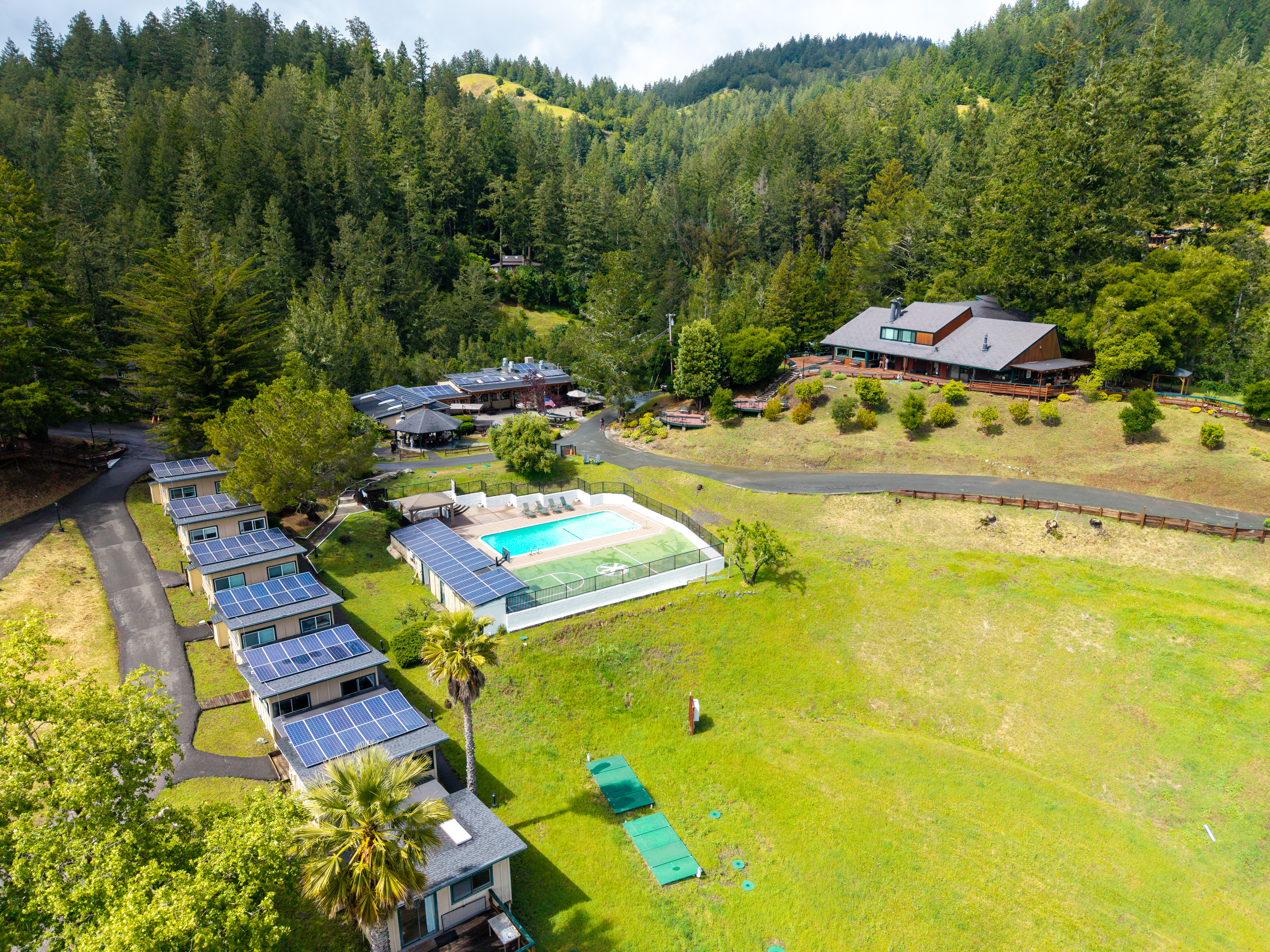 Aerial view of Serenity Knolls Treatment Center surrounded by trees and landscaped grounds in Forest Knolls, California.