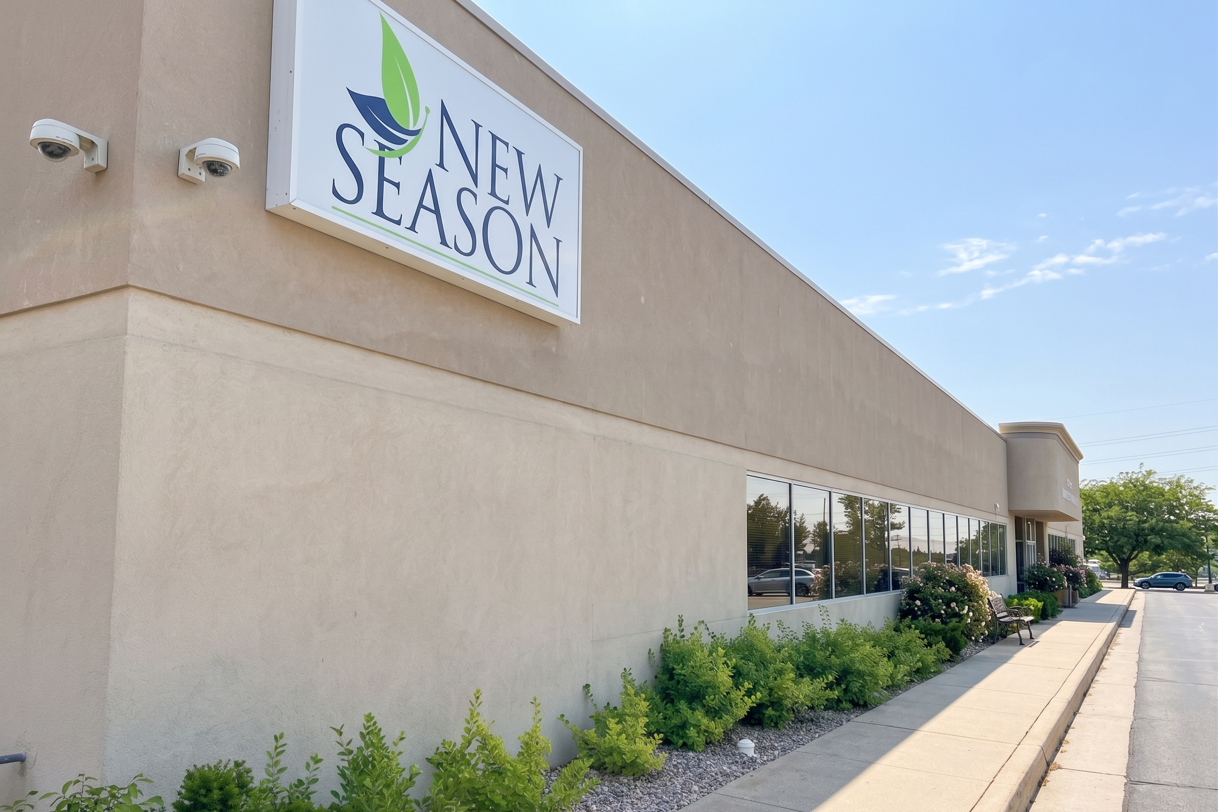 New Season facility exterior with sign and landscaped walkway